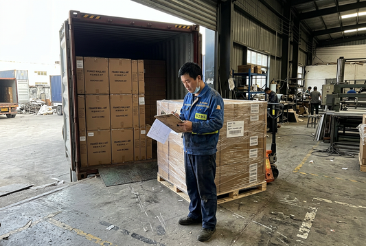 Real factory shipping bay with logistics personnel verifying export manifest beside palletized wall art cargo and container loading dock
